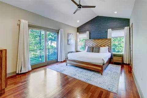 a bedroom with a large bed and a large window