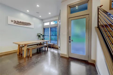 a hallway with wooden floor furniture and a kitchen