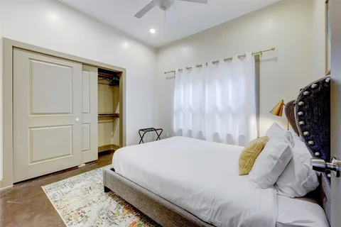 a bedroom with a bed and a walk in closet