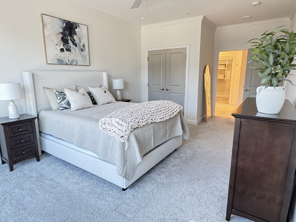 1 Revolution Way, Unit 307 Canton, MA 02021 - Photo 11 of 31 a spacious bedroom with a bed and a couch