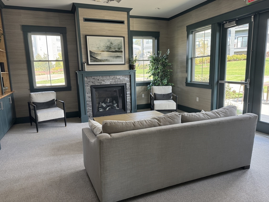 1 Revolution Way, Unit 307 Canton, MA 02021 - Photo 26 of 31 a living room with furniture and a fireplace