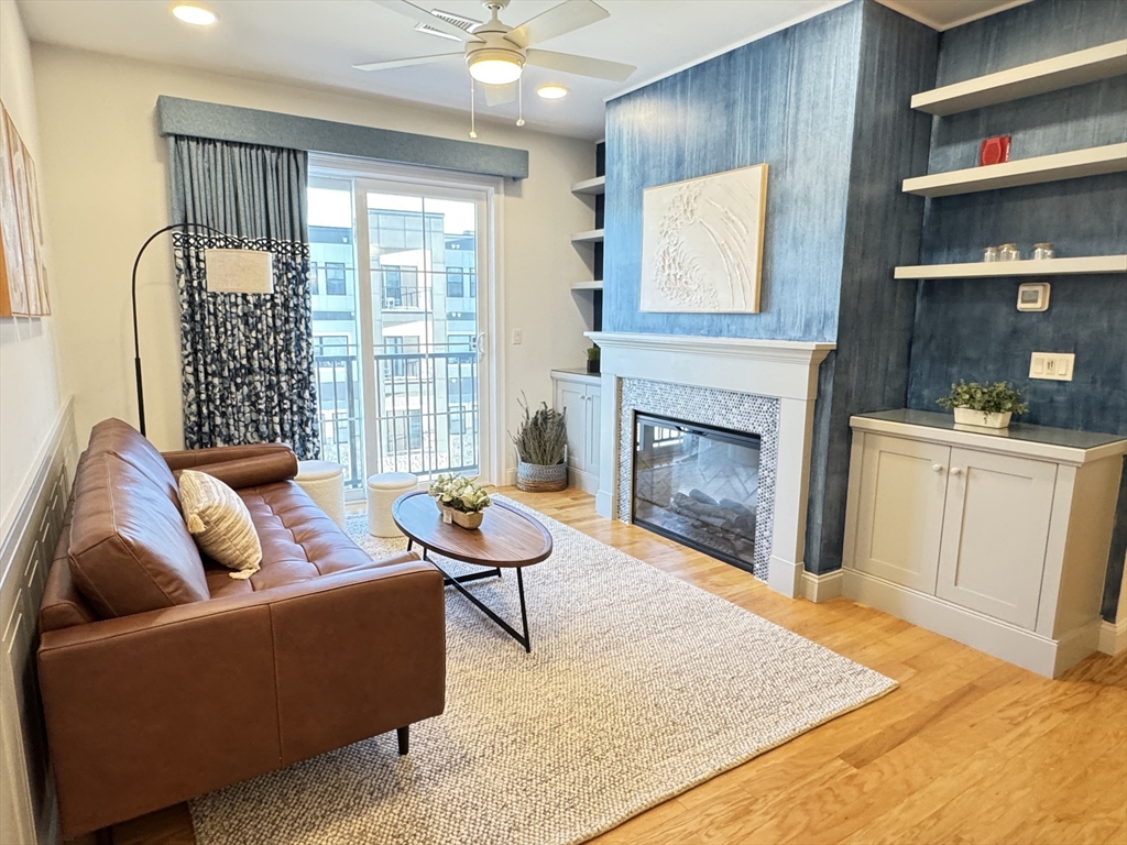 1 Revolution Way, Unit 307 Canton, MA 02021 - Photo 3 of 31 a living room with furniture and a fireplace