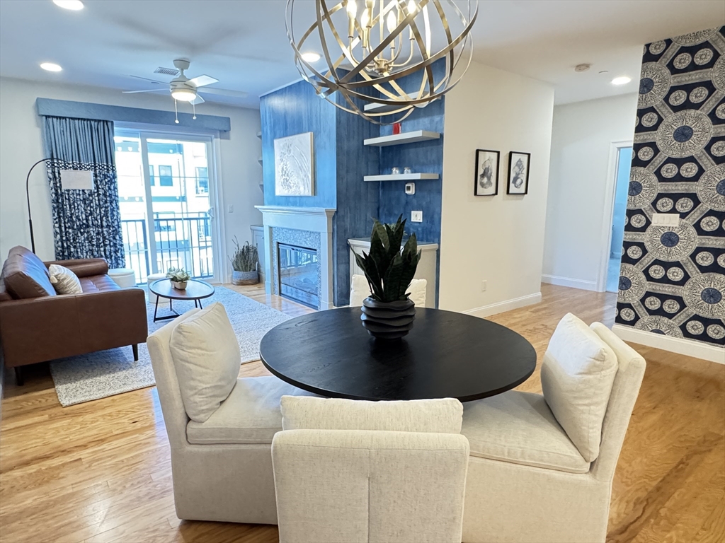 1 Revolution Way, Unit 307 Canton, MA 02021 - Photo 6 of 31 a living room with furniture and a chandelier