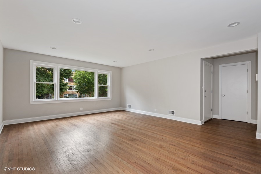 1619 Monroe Street, Unit 1 Evanston, IL 60202 - Photo 3 of 10 a view of an empty room with wooden floor and a window