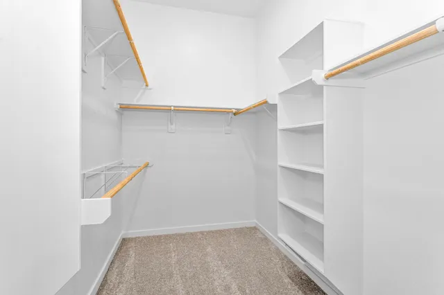 a view of walk in closet with empty racks