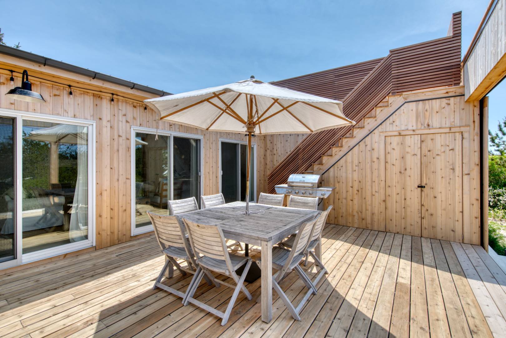 9 Marlin Drive Amagansett, NY 11930 - Photo 13 of 20 a view of a patio with table and chairs with wooden floor and fence