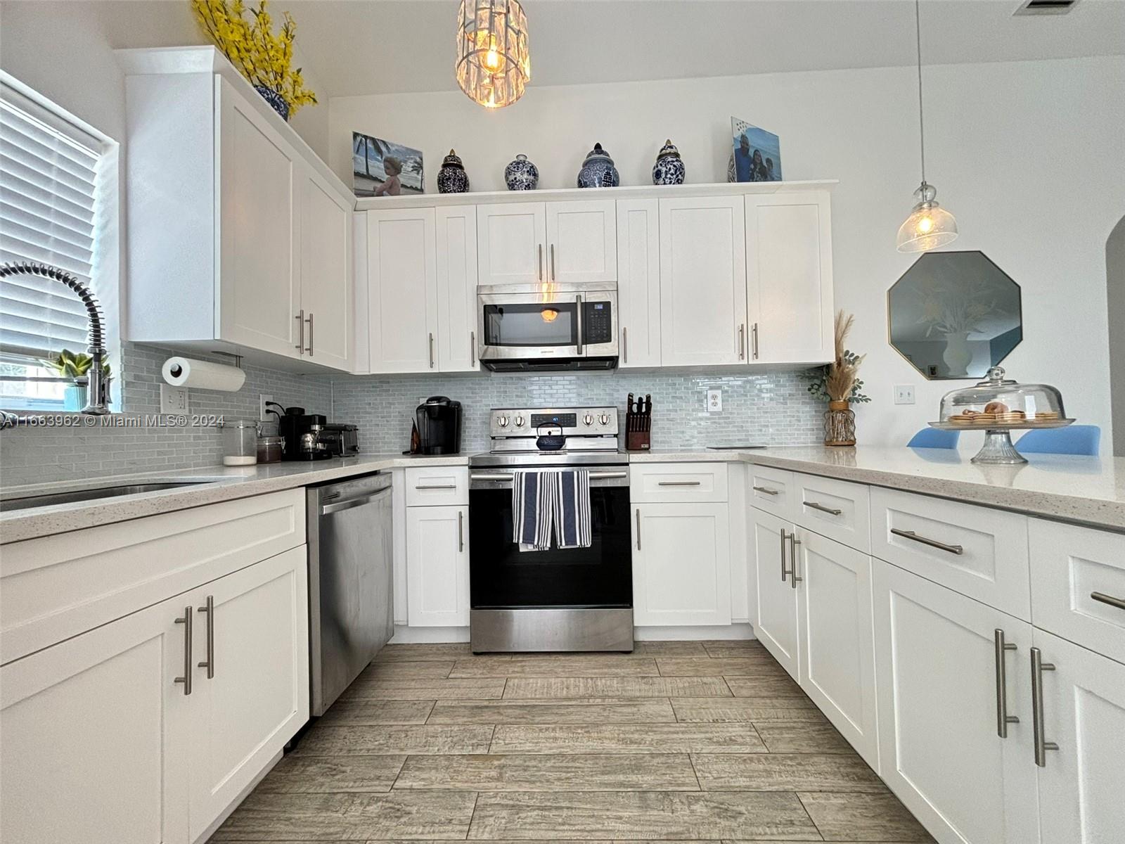 14170 Southwest 151st Avenue Miami, FL 33196 - Photo 13 of 23 a kitchen with cabinets stainless steel appliances and a sink