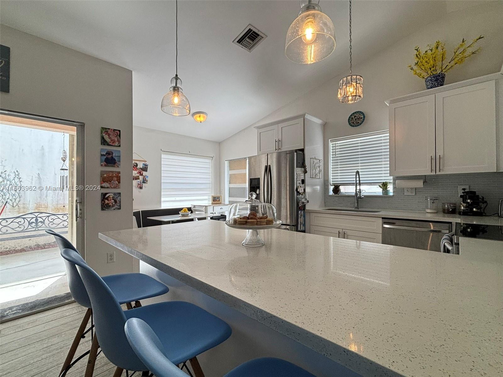 14170 Southwest 151st Avenue Miami, FL 33196 - Photo 15 of 23 a large kitchen with a table and chairs