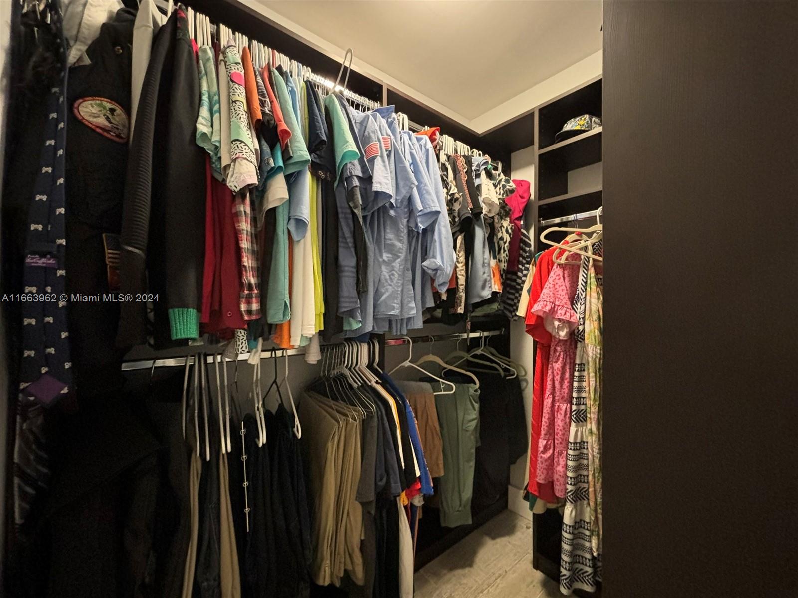 14170 Southwest 151st Avenue Miami, FL 33196 - Photo 19 of 23 a view of walk in closet with clothes and shoes
