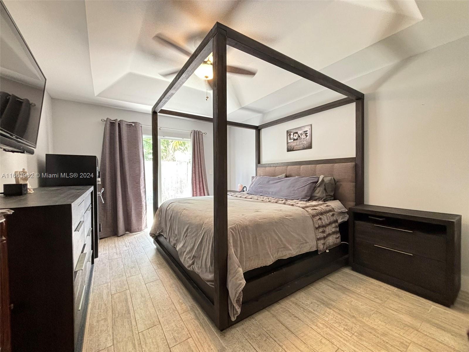 14170 Southwest 151st Avenue Miami, FL 33196 - Photo 20 of 23 a bedroom with a bed and a tv