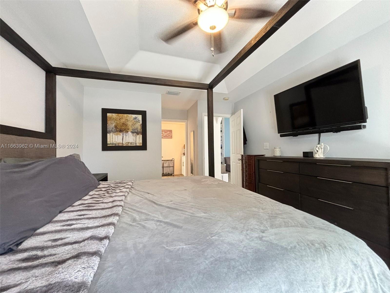 14170 Southwest 151st Avenue Miami, FL 33196 - Photo 22 of 23 a bedroom with a bed and a flat screen tv