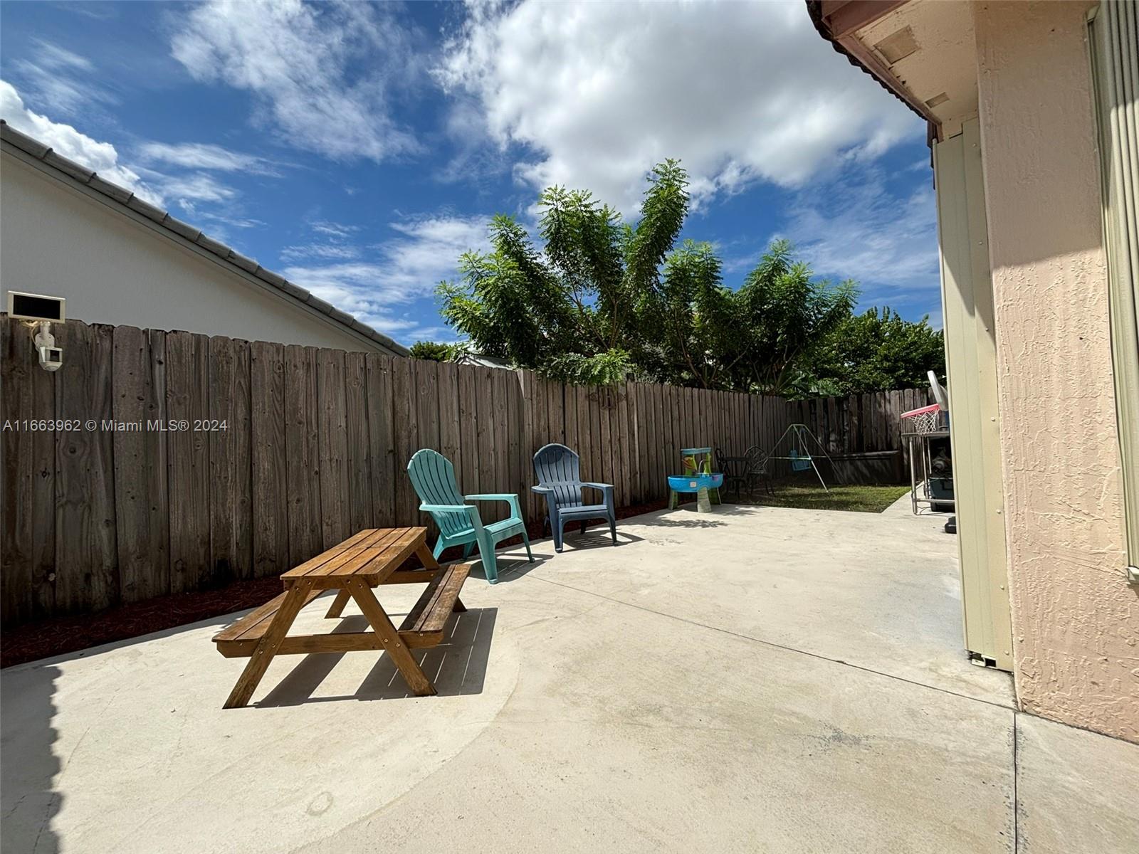 14170 Southwest 151st Avenue Miami, FL 33196 - Photo 23 of 23 a view of backyard with a table and chairs