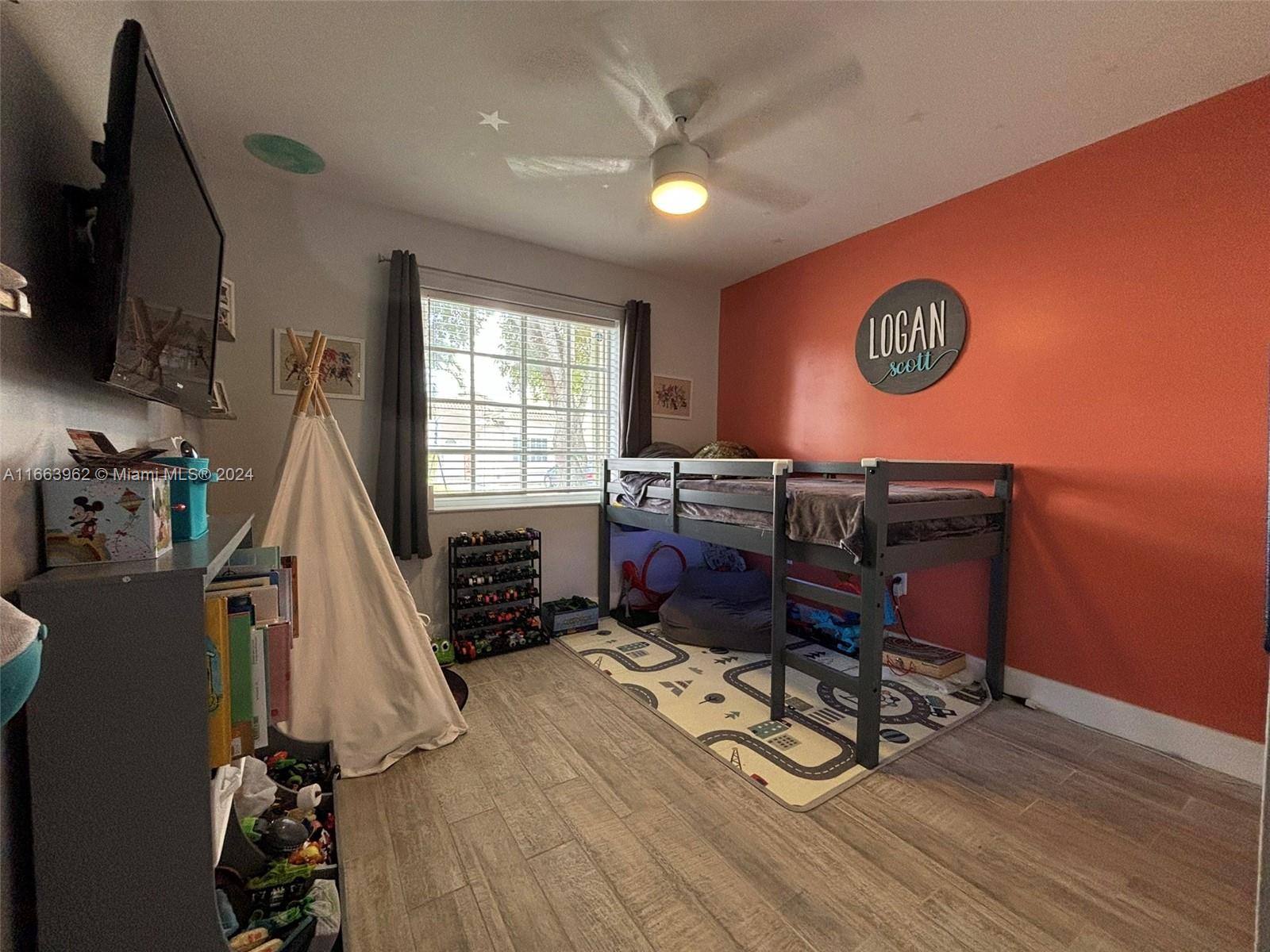 14170 Southwest 151st Avenue Miami, FL 33196 - Photo 5 of 23 a living room with furniture a flat screen tv and a wooden floor