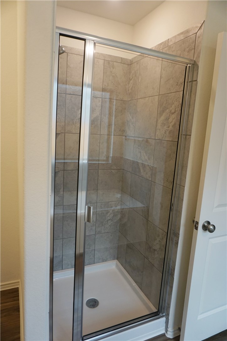 3493 Pauling Loop Round Rock, TX 78665 - Photo 10 of 19 a bathroom with a glass shower door