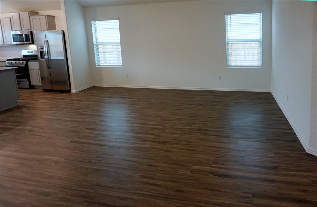 3493 Pauling Loop Round Rock, TX 78665 - Photo 4 of 19 an empty room with wooden floor and windows