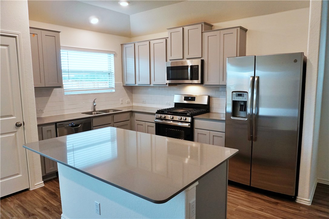3493 Pauling Loop Round Rock, TX 78665 - Photo 7 of 19 a kitchen with stainless steel appliances a microwave a sink a stove and refrigerator
