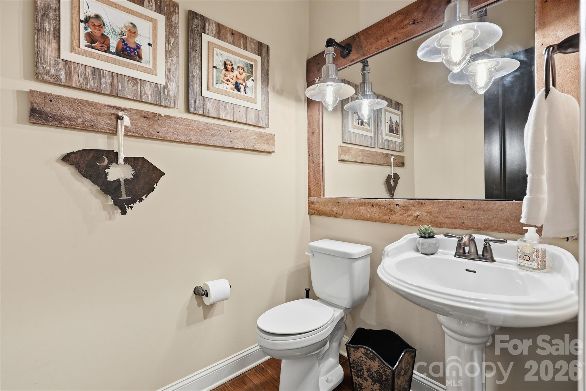 8094 Clems Branch Road Indian Land, SC 29707 - Photo 17 of 38 a bathroom with a sink a toilet and mirror
