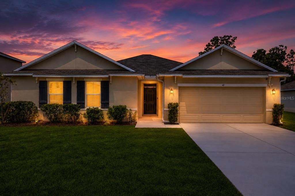 48 Hickory Loop Ocala, FL 34472 - Photo 1 of 52 a front view of a house with a yard and garage
