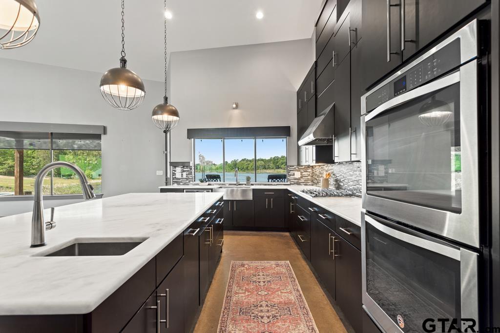 24116 Sun Ridge Road Lindale, TX 75771 - Photo 13 of 47 a large kitchen with granite countertop a stove and a sink