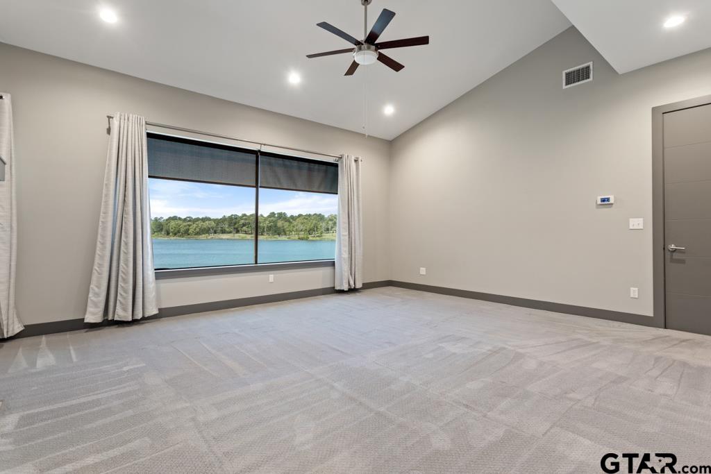 24116 Sun Ridge Road Lindale, TX 75771 - Photo 18 of 47 an empty room with a ceiling fan and window
