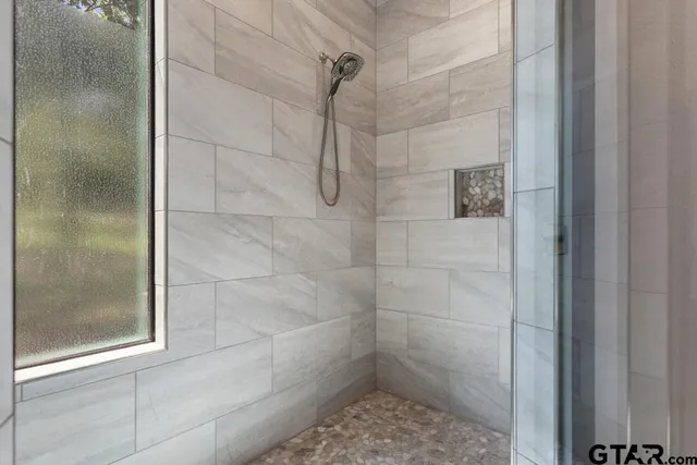 a spacious bathroom with a granite countertop sink and a mirror