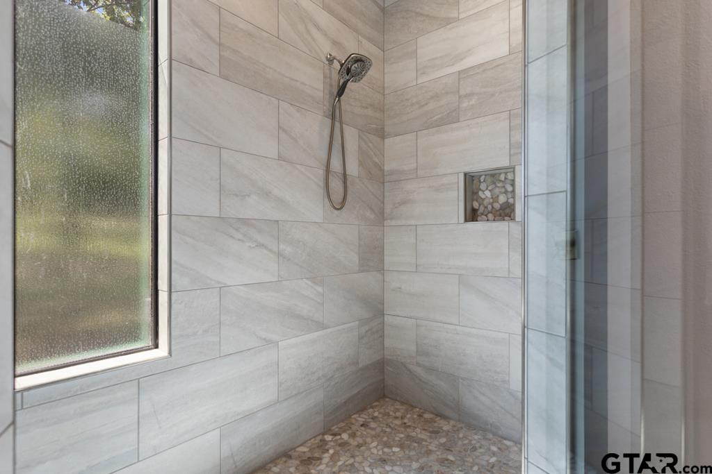 24116 Sun Ridge Road Lindale, TX 75771 - Photo 22 of 47 a bathroom with a glass shower door