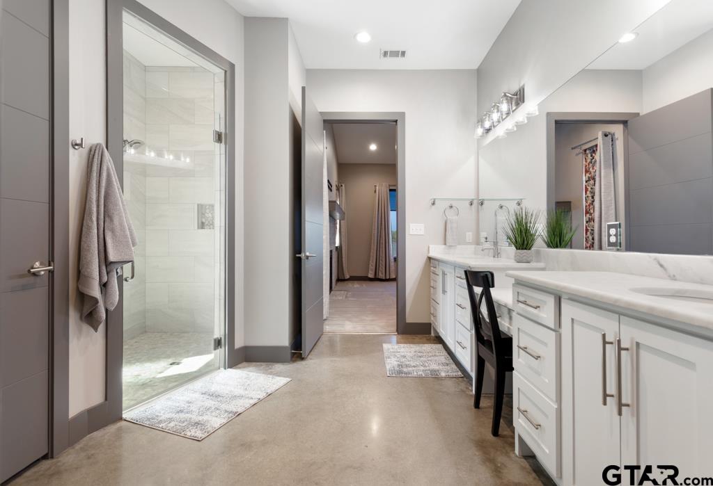 24116 Sun Ridge Road Lindale, TX 75771 - Photo 23 of 47 a spacious bathroom with a granite countertop sink and a mirror
