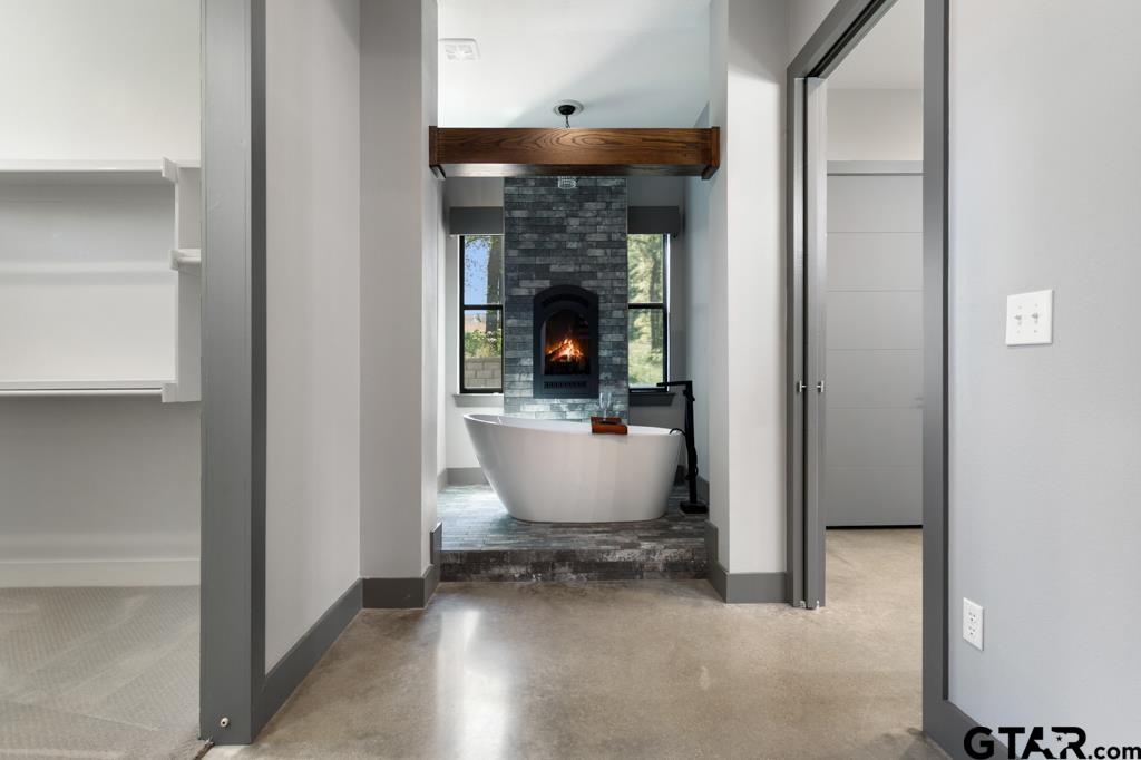 24116 Sun Ridge Road Lindale, TX 75771 - Photo 24 of 47 a room with wooden floor and a fireplace