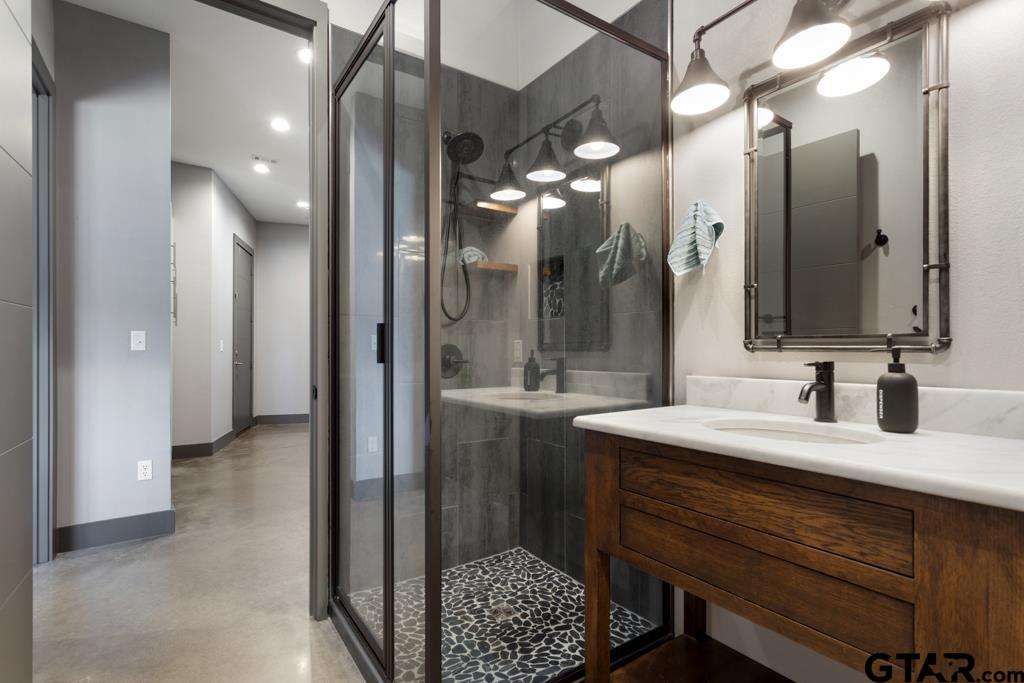 24116 Sun Ridge Road Lindale, TX 75771 - Photo 28 of 47 a bathroom with a sink a mirror and a shower