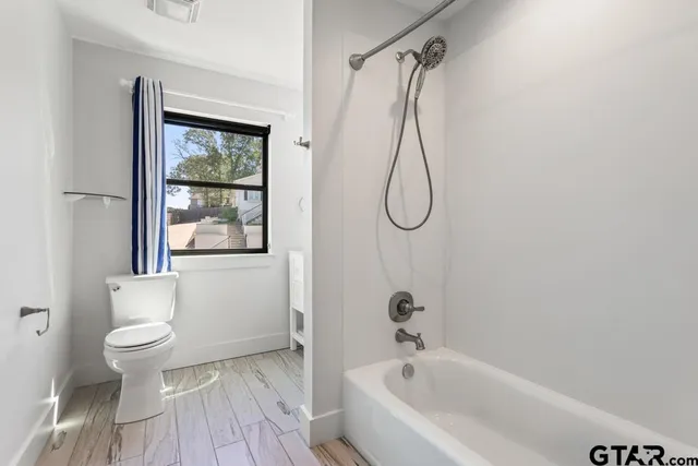 a bathroom with a granite countertop sink mirror and vanity