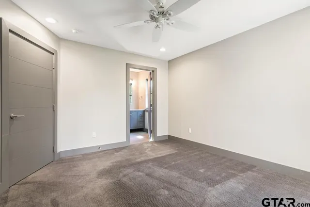 a bathroom with a granite countertop sink and a large mirror next to a window