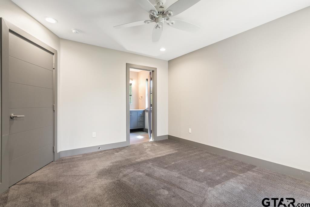 24116 Sun Ridge Road Lindale, TX 75771 - Photo 36 of 47 an empty room with a chandelier fan and closet