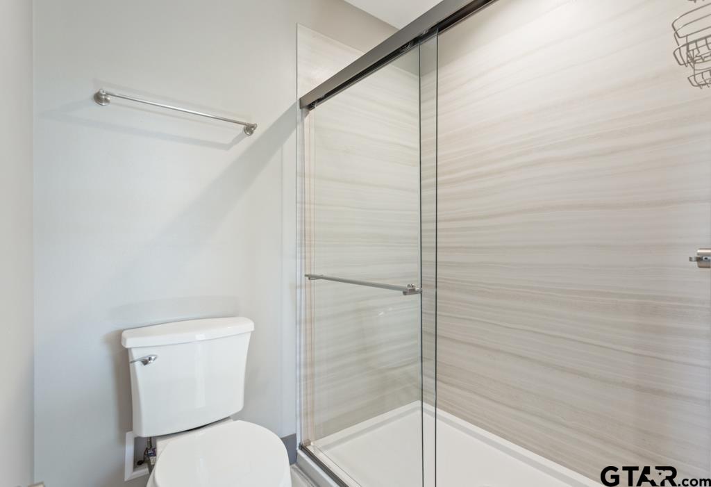 24116 Sun Ridge Road Lindale, TX 75771 - Photo 38 of 47 a bathroom with a toilet and a shower