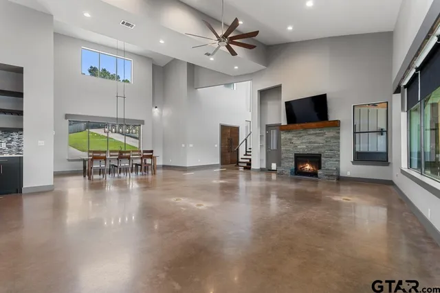 a view of a livingroom with furniture a flat screen tv and fireplace
