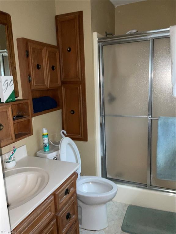 1202 Pilot School Road Thomasville, NC 27360 - Photo 12 of 15 Look at this remodeled bathroom - tile flooring, granite tops AND custom tile bath surround.