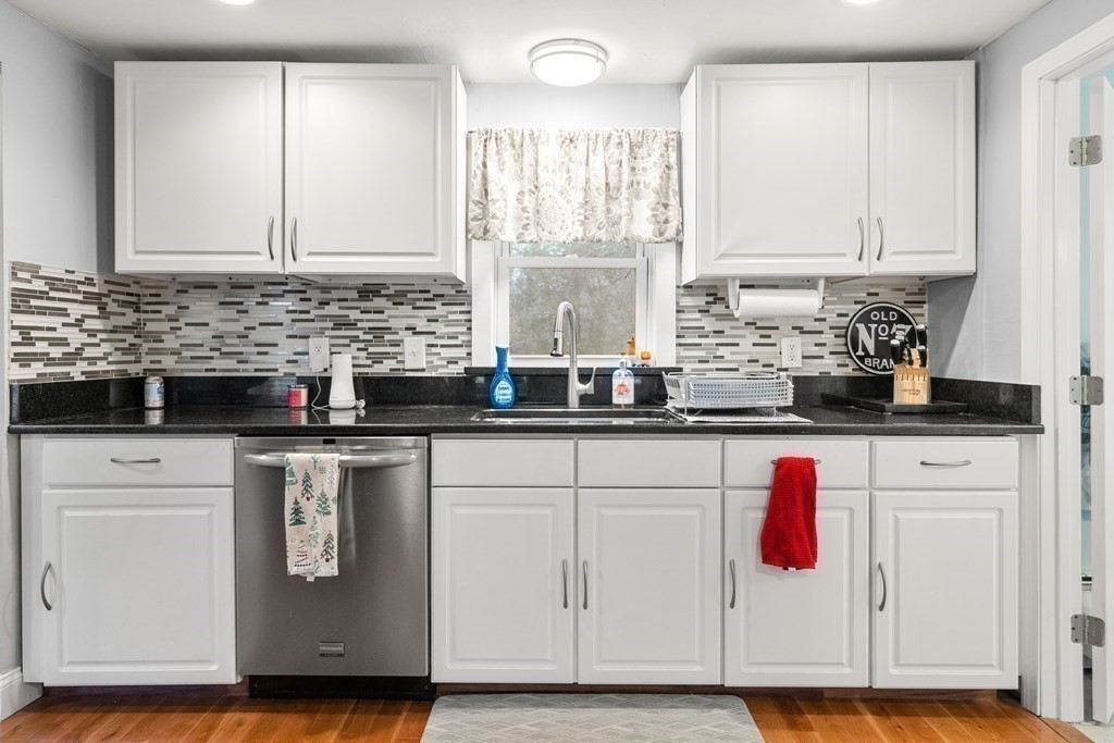 653 Walnut Plain Road Rochester, MA 02770 - Photo 11 of 30 a kitchen with stainless steel appliances granite countertop a sink a stove and a wooden cabinets