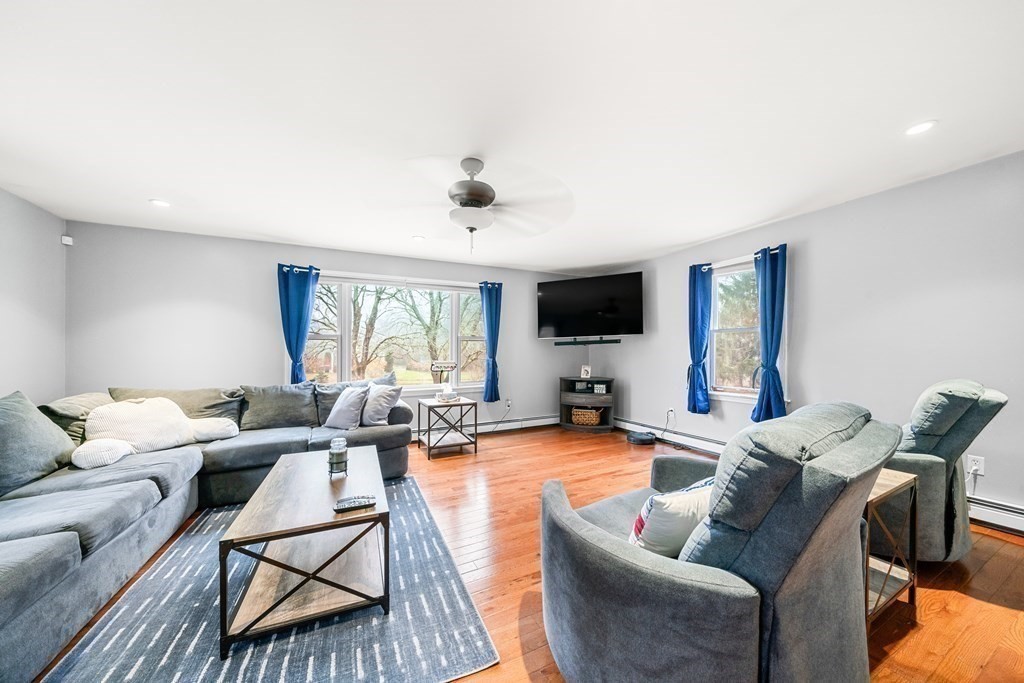 653 Walnut Plain Road Rochester, MA 02770 - Photo 6 of 30 a living room with furniture and a flat screen tv