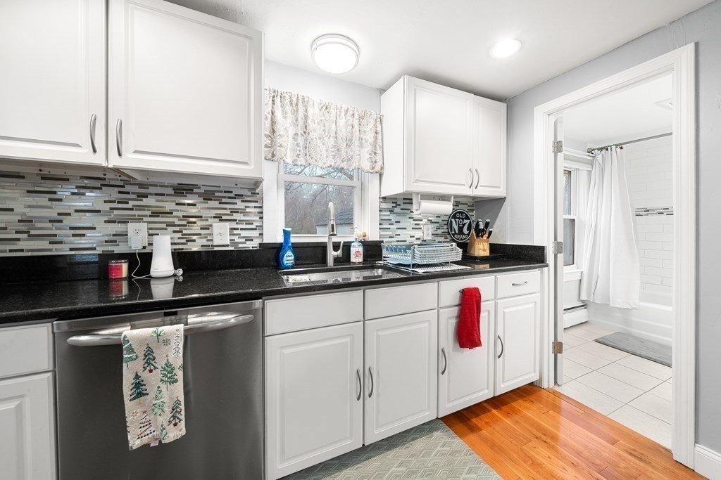 653 Walnut Plain Road Rochester, MA 02770 - Photo 10 of 30 a kitchen with stainless steel appliances granite countertop a sink and cabinets
