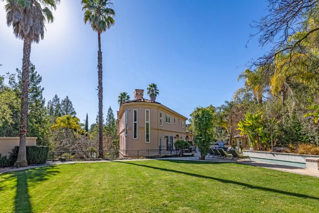 a bathroom with a granite countertop sink a toilet and a mirror