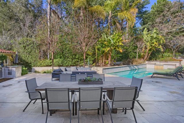 a bathroom with a granite countertop sink a toilet and a mirror