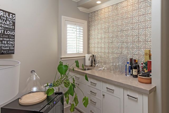 a front view of a house with a yard and shrubs