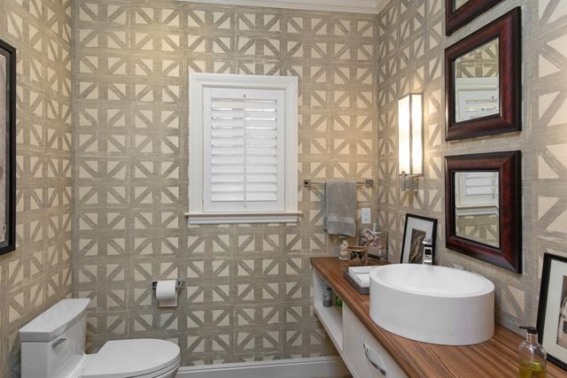 a front view of a house with a yard and potted plants