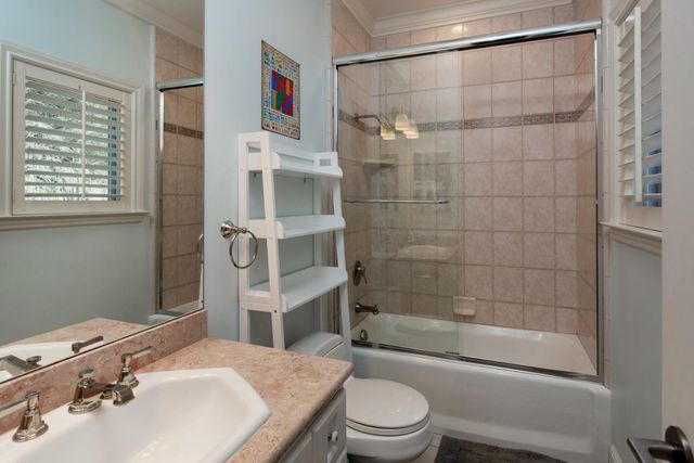 a view of a room with gym equipment and wooden floor