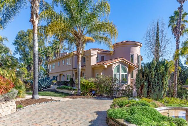 a view of a bedroom with furniture and a window