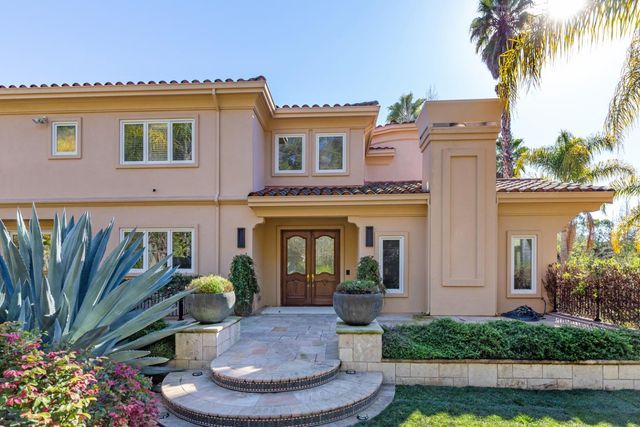 a front view of a house with a garden
