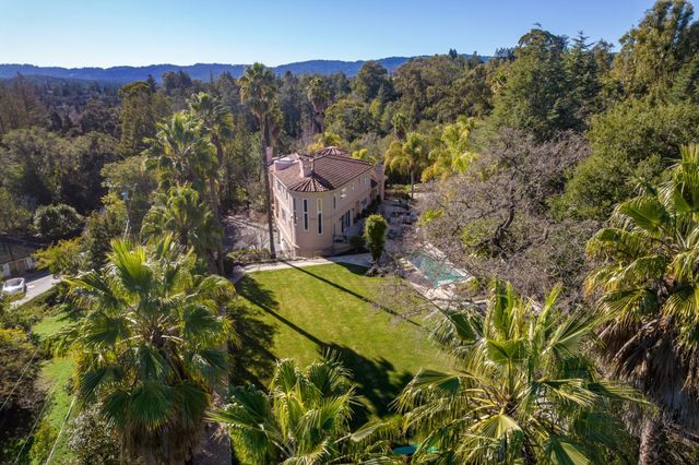 an aerial view of a house with a yard