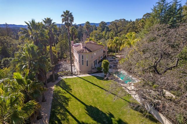 an aerial view of a house with a yard