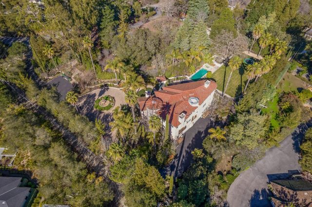 a view of backyard with a table and chairs with a fire pit