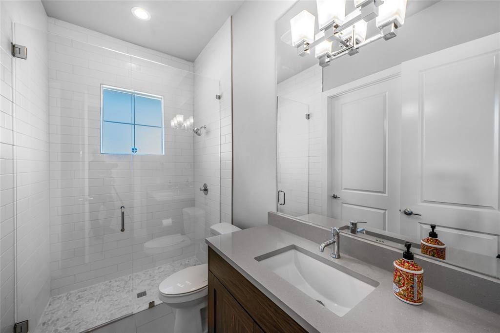 7807 Ryans Way Austin, TX 78726 - Photo 13 of 16 a bathroom with a sink a toilet and shower