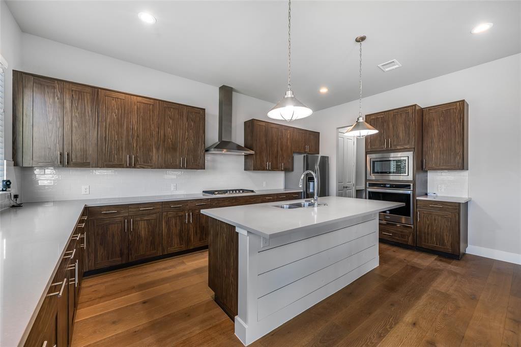 7807 Ryans Way Austin, TX 78726 - Photo 3 of 16 a kitchen with a sink stainless steel appliances and cabinets